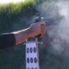 pistol being shot at a range outdoors
