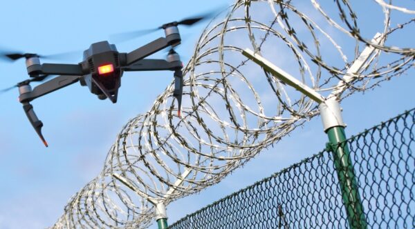 drone flying near barbed wire fence